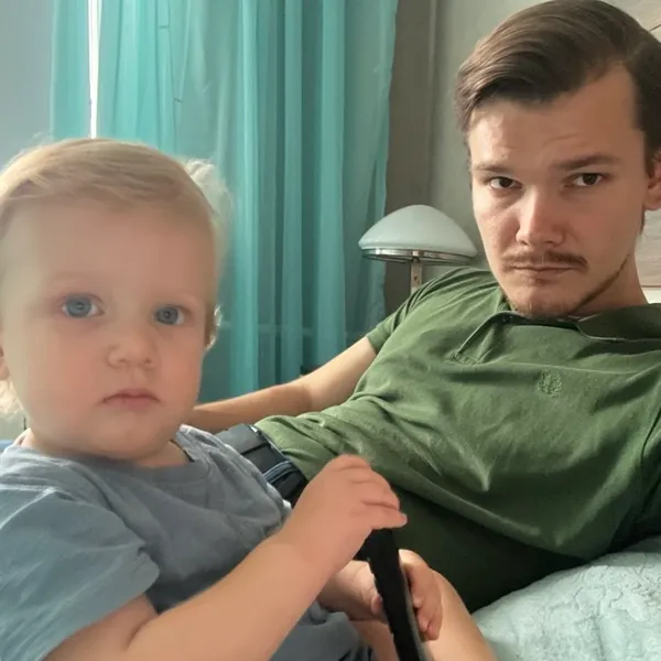 A selfie of Tim and Timofey at home, both looking very serious.